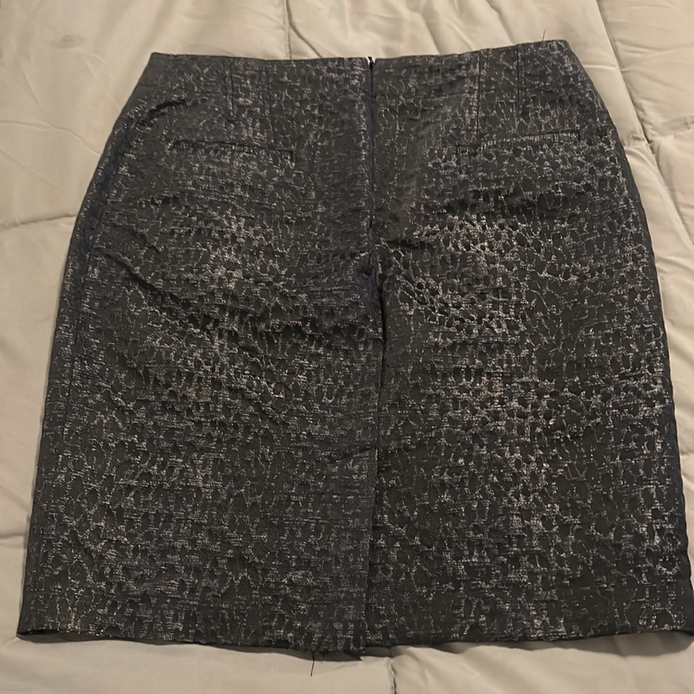 Size 8 Black with blue zip up animal print skirt. - Picture 2 of 5